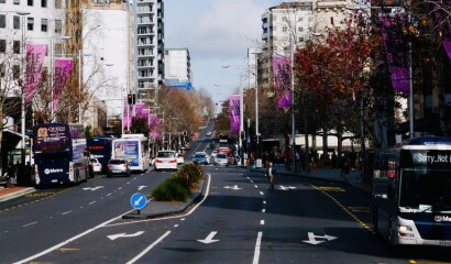 Buses and other traffic driving along an Auckland street