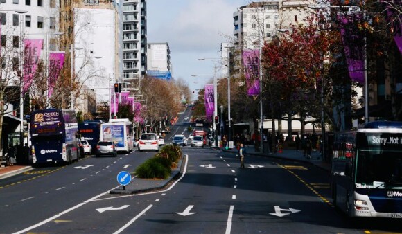 Buses and other traffic driving along an Auckland street